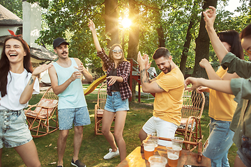 Image showing Happy friends are having beer and barbecue party at sunny day