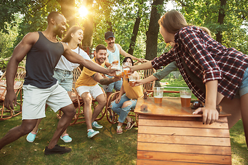 Image showing Happy friends are having beer and barbecue party at sunny day