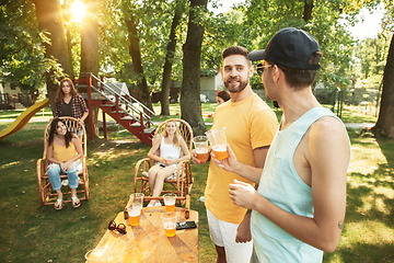 Image showing Happy friends are having beer and barbecue party at sunny day