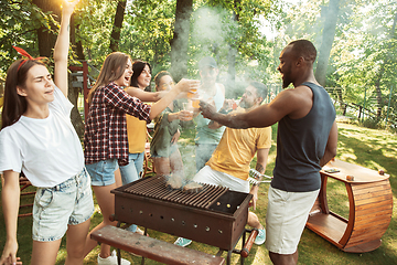 Image showing Happy friends are having beer and barbecue party at sunny day