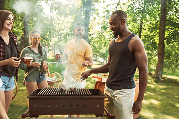 Image showing Happy friends are having beer and barbecue party at sunny day