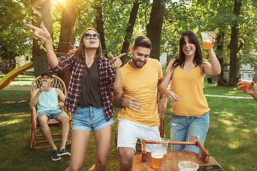 Image showing Happy friends are having beer and barbecue party at sunny day