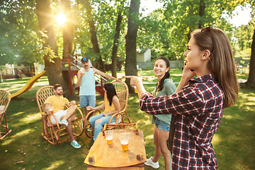 Image showing Happy friends are having beer and barbecue party at sunny day