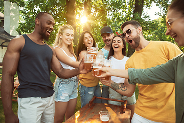 Image showing Happy friends are having beer and barbecue party at sunny day