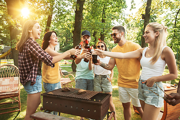 Image showing Happy friends are having beer and barbecue party at sunny day