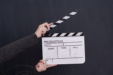 Image showing movie clapper on balck chalkboard background