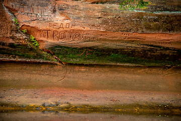 Image showing Red sandstone cliff near the river.