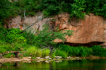 Image showing Red sandstone cliff on coast of the river 