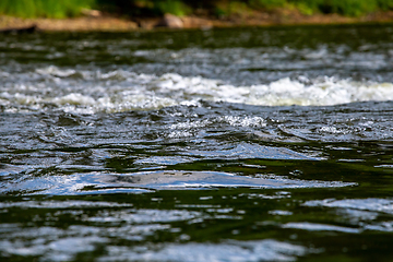 Image showing Reflections in shallow river as background.