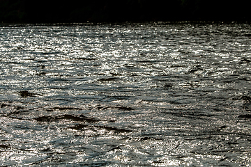 Image showing Reflections in shallow river as background.