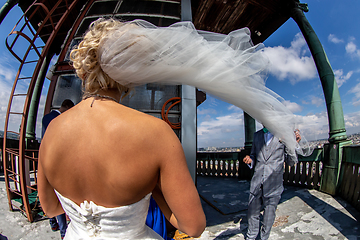 Image showing Bride with groom in church on blue sky background.