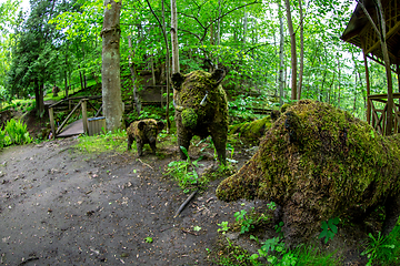 Image showing Wild boar sculptures in green park