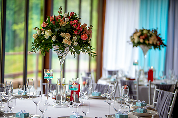 Image showing Bouquet of flowers and glasses on the wedding table