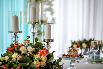 Image showing Candles and flowers on festive table