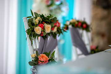 Image showing Bouquet of roses tied on the chair 