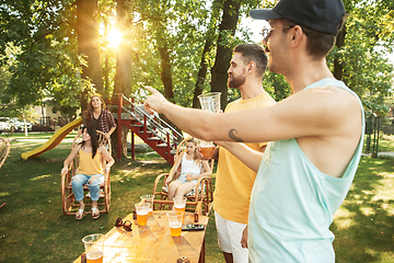 Image showing Happy friends are having beer and barbecue party at sunny day