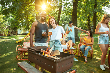 Image showing Happy friends are having beer and barbecue party at sunny day