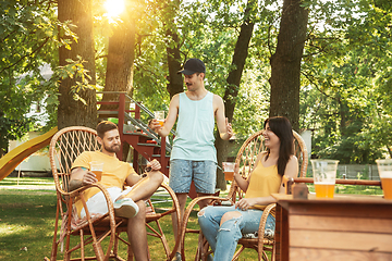 Image showing Happy friends are having beer and barbecue party at sunny day