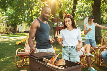 Image showing Happy friends are having beer and barbecue party at sunny day