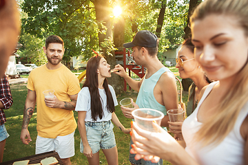 Image showing Happy friends are having beer and barbecue party at sunny day