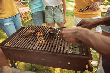 Image showing Close up of meat grilling, barbecue, summer lifestyle