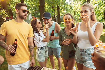 Image showing Happy friends are having beer and barbecue party at sunny day