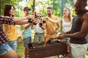 Image showing Happy friends are having beer and barbecue party at sunny day