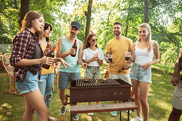 Image showing Happy friends are having beer and barbecue party at sunny day