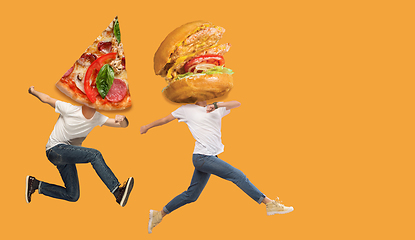 Image showing Fast food concept. Young people running on orange background