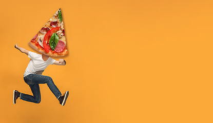 Image showing Fast food concept. Young people running on orange background