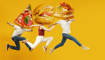 Image showing Fast food concept. Young people running on orange background