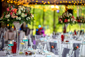 Image showing Wedding table decorated with flowers and dishes