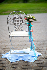 Image showing Chair with  flowers and towels