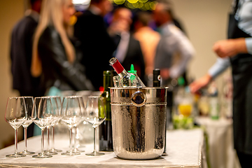 Image showing Ice bucket,  wine bottles and glasses on table