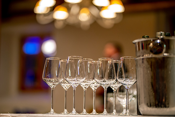 Image showing Wine glasses, bottles and ice bucket on table