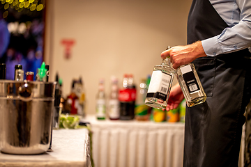 Image showing Waiter with whiskey bottles in wedding