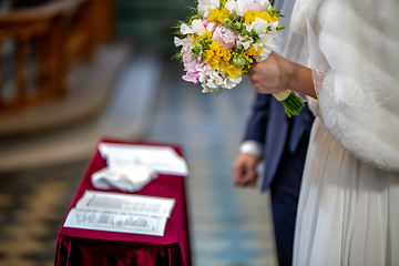 Image showing Bouquet of flowers in the hand of the bride during the marriage 