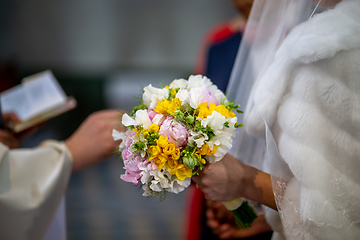 Image showing Bouquet of flowers in the hand of the bride during the marriage 