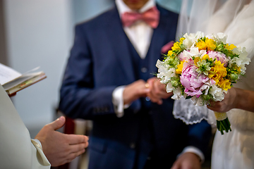 Image showing Bouquet of flowers in the hand of the bride during the marriage 