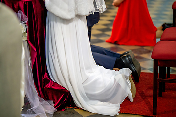 Image showing Bride and groom during wedding ceremony in church.