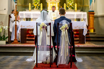 Image showing Bride and groom during wedding ceremony in church.