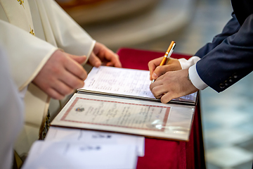 Image showing Groom signs document on registration of marriage