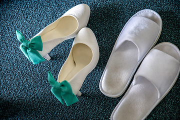 Image showing White bridal shoes and white slippers