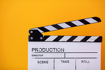 Image showing movie clapper on yellow background