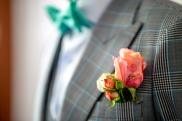 Image showing Pink rose in the groom's in pocket of jacket