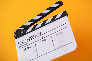 Image showing movie clapper on yellow background