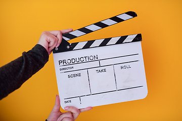 Image showing movie clapper on yellow background