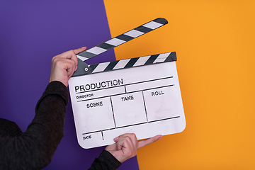 Image showing movie clapper on purple background