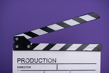 Image showing movie clapper on purple background