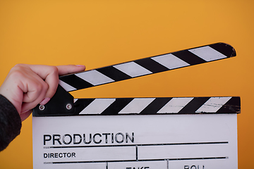 Image showing movie clapper on yellow background